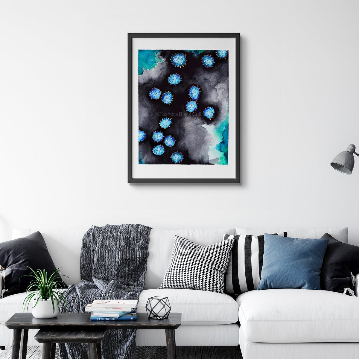 Coronavirus watercolor print framed on a wall behind couch.